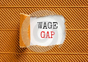 Wage gap symbol. Concept words Wage gap on beautiful white paper on a beautiful brown paper background. Business, support and wage