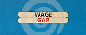 Wage gap symbol. Concept words Wage gap on beautiful wooden stick on a beautiful blue table blue background. Business, support and