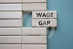 Wage Gap symbol. Concept words Wage Gap on wooden blocks. Beautiful grey green background. Business and Wage Gap concept. Copy