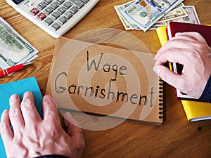 Wage Garnishment is shown on the conceptual business photo