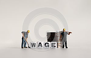 `WAGE` text in white cube. Miniature worker and pile of coins.