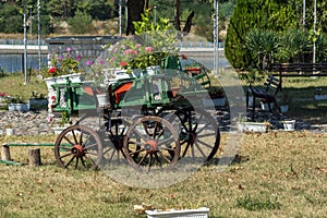 Wagon covered with flowers in the yard in Monastery St. John the Baptist, Kardzhali