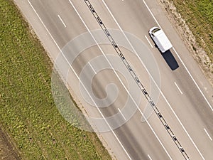 Wagon driving on the highway, aerial. Transport logistics background top view.