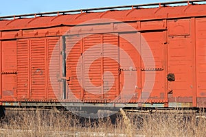 Wagon of an old rusty freight train stands on the rails