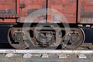 Wagon of an old rusty freight train stands on the rails