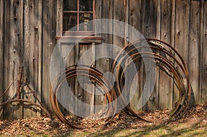 Wagon Wheel Rims Leaning on a Rustic Building