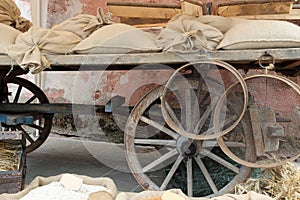 wagon with wooden wheels and the jute sacks over