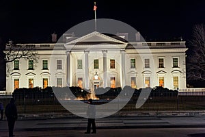 WAHINGTON, D.C. - JANUARY 09, 2014: White House at night. With Police Officer in foreground.