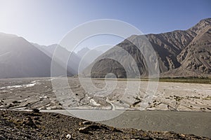 Wahkan valley in Tajikistan. Above the river is Afghanistan with the Hindu Kush