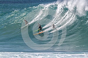 Waimea Bay HI, Surfers riding a wave