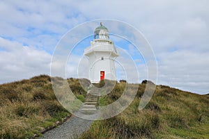 Waipapa Point Lighthouse with a cloudy sky