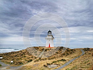 Waipapa Point lighthouse of the Southern Otago region of the South Island of New Zealand under greyish moody sky