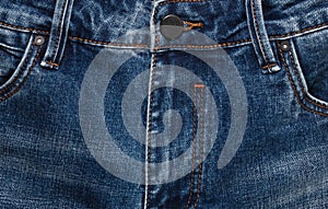 Waist area, zipper, and its button of dark blue jeans. Close up shot. Clothing concept
