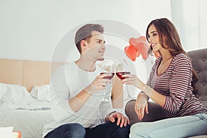 Waist up of adorable couple drinking wine together