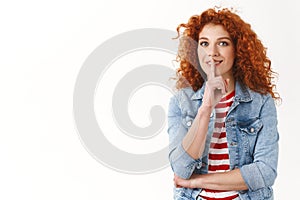 Waist-up happy redhead curly cheerful feminine woman hiding interesting surprise shushing have secret show shhh sign