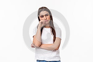 Waist-up portrait of bored, uninterested young brunette female in glasses, feel tired or sleepy, listening to boring