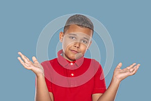 Waist up portrait of a boy  with an expression on his face  regretting something and spreading his arms to the side, isolated on