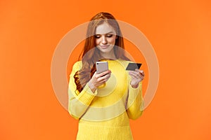 Waist-up portrait carefree modern young girl making online purchase, shopping internet using mobile application, insert