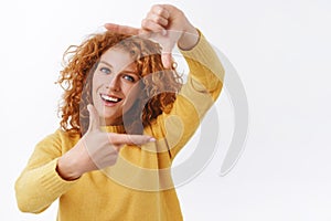 Waist-up portrait, creative good-looking redhead curly woman in yellow sweater, photographer or designer search perfect