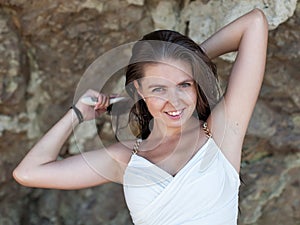 Waist-up portrait of girl on rocky beach