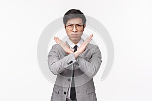 Waist-up portrait of serious-looking determined young asian businessman promise to stop harassment in his office, forbid