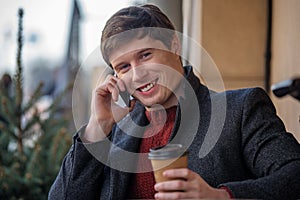 Handsome guy talking on cell phone while smiling