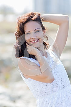 Waist up portrait of young woman in white sleeveless dress