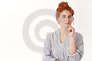 Waist-up shot ambitious, creative redhead female think-up perfect plan, comb curly ginger hair in bun, smirk with