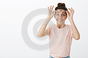 Waist-up shot of happy girl cheering, feeling joyful as taking off glasses and putting on contact lenses seeing clearly