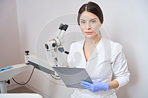 Waist up woman gynecologist is standing in the clinic office