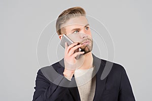 Wait connection. Man well groomed speak mobile phone grey background. Businessman serious call mobile phone. Mobile call