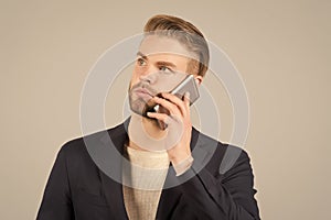 Wait connection. Man well groomed speak mobile phone grey background. Businessman serious call mobile phone. Mobile call