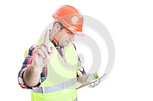 Wait a minute concept with constructor holding tablet photo