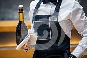 Waiter in a restaurant with a bottle of prosecco