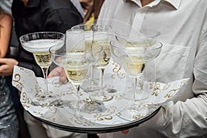 Waiter carrying a tray with champagne glasses