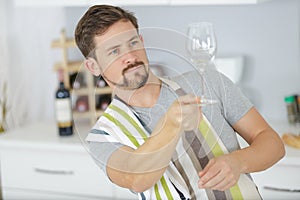 Waiter cleaning wine glass