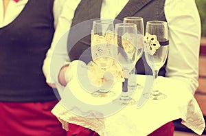 Waiter with empty champagne glasses