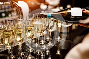 Waiter filling a glass of champagne in a restaurant