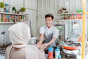 Waiter gives the food to the woman