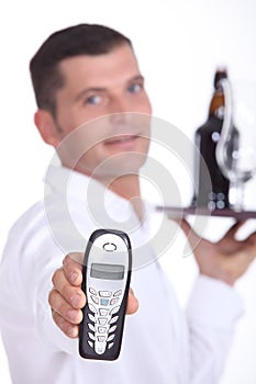 Waiter holding cell phone