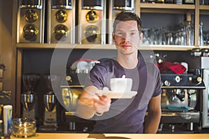 Waiter holding coffee cup