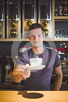 Waiter holding coffee cup
