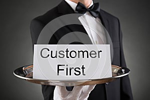 Waiter Holding Customer First Card On Tray