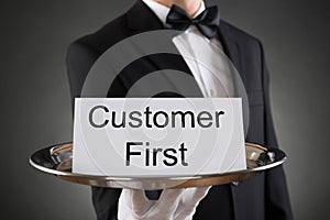 Waiter Holding Customer First Card On Tray photo