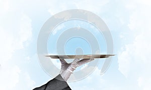 Waiter holding empty silver platter ready for product or item placement