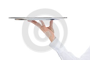 Waiter holding empty silver tray photo