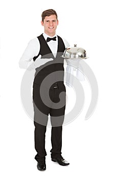 Waiter holding empty silver tray
