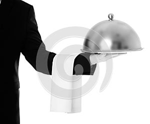 Waiter holding metal tray with lid on white background photo