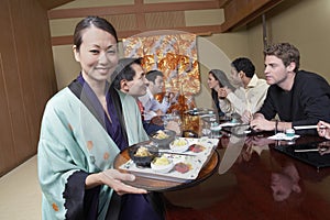 Waiter Holding Plates To Serve Food