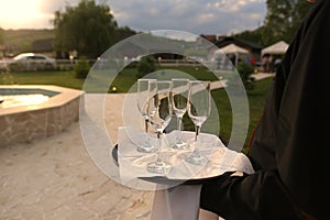 Waiter holding a tray with champagne glasses